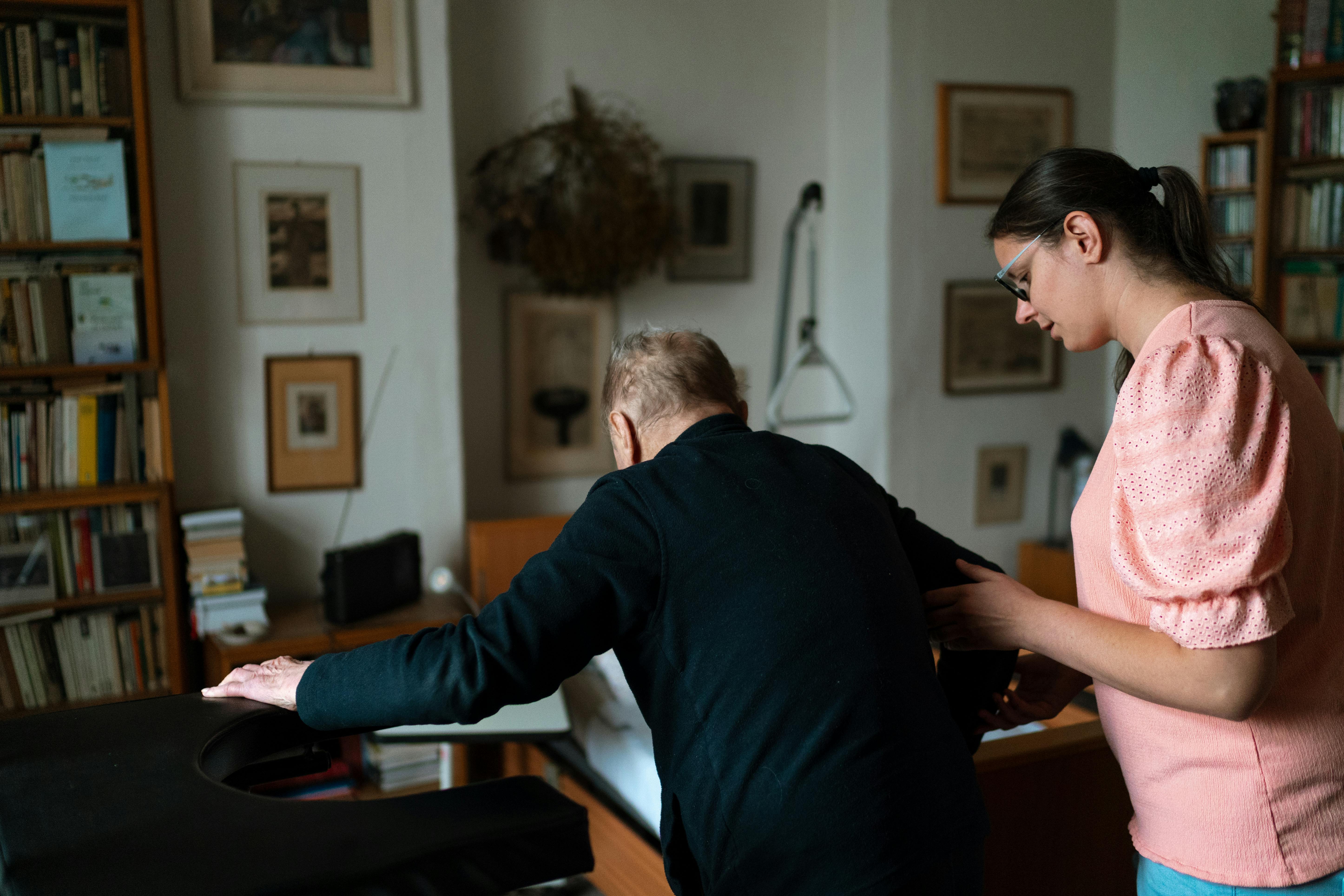 Support worker assisting an older adult at home